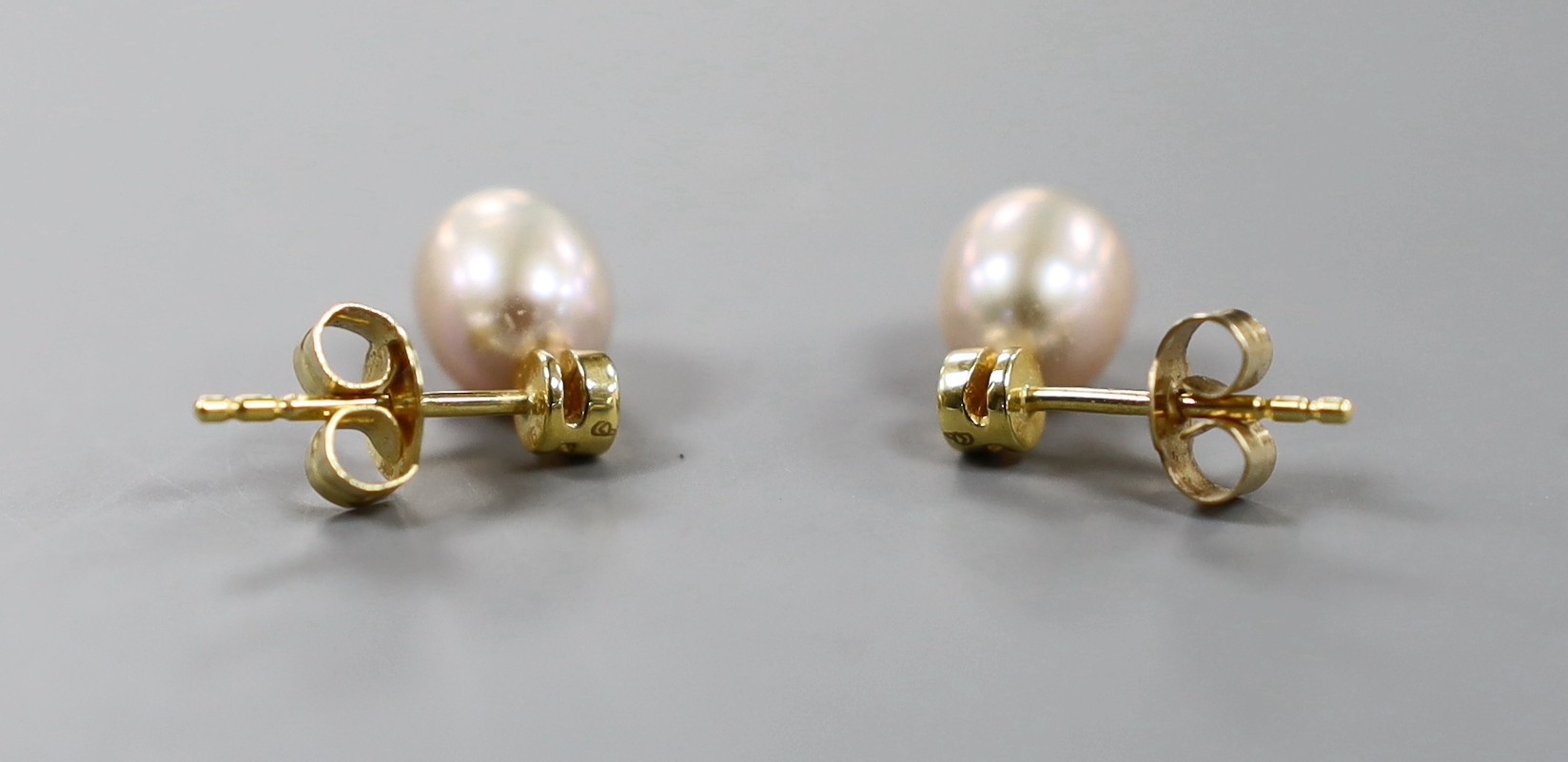 A modern pair of 18ct gold, cultured pearl and diamond set ear studs, 12mm, gross weight 2.3 grams.